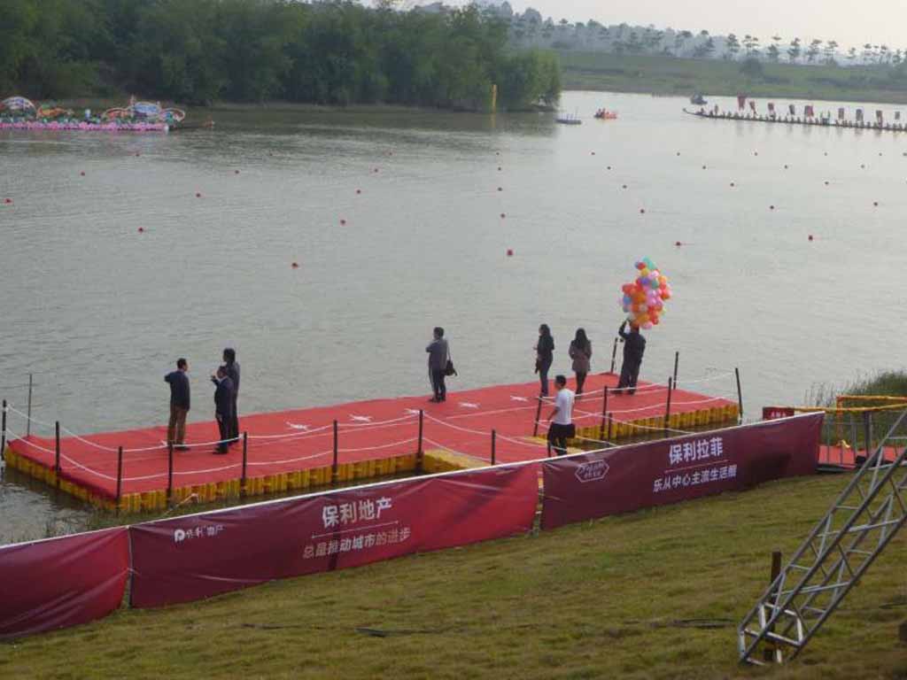 Engineered floating stages for public events 200-person floating event platform hosting concert with safety railings