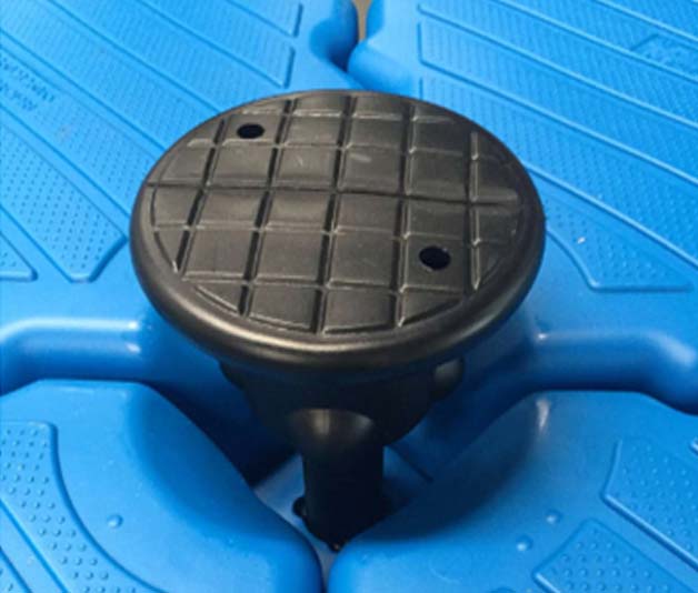 Worker securing interlocking HDPE dock modules with corrosion-resistant shear pins, creating seamless joint with ±15° wave compensation capability