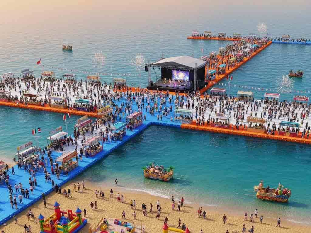 Tourism festival at hainan featuring tourist boat , water fun and food stalls