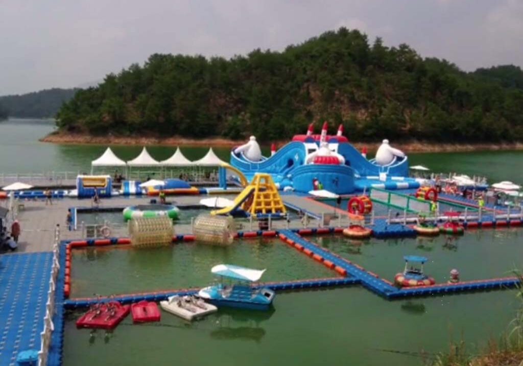 Family enjoying a waterfront leisure dock at a resort, featuring non-slip surfaces and safety railings